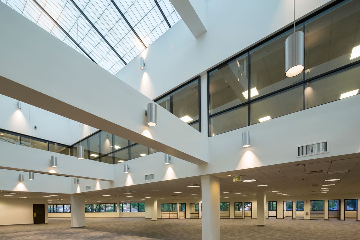 A bright, open production office floor with skylights at The Burbank Studios